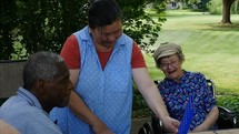 A caregiver playing a game with elderly patients at a care home