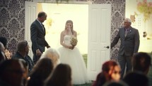 Bride's entrance at an outdoor wedding.