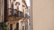 Beautiful balcony and sicilian street in Italy