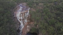 Drone hovers high over waterfall