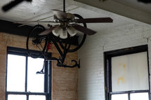 ceiling fan and bike hanging from a ceiling 