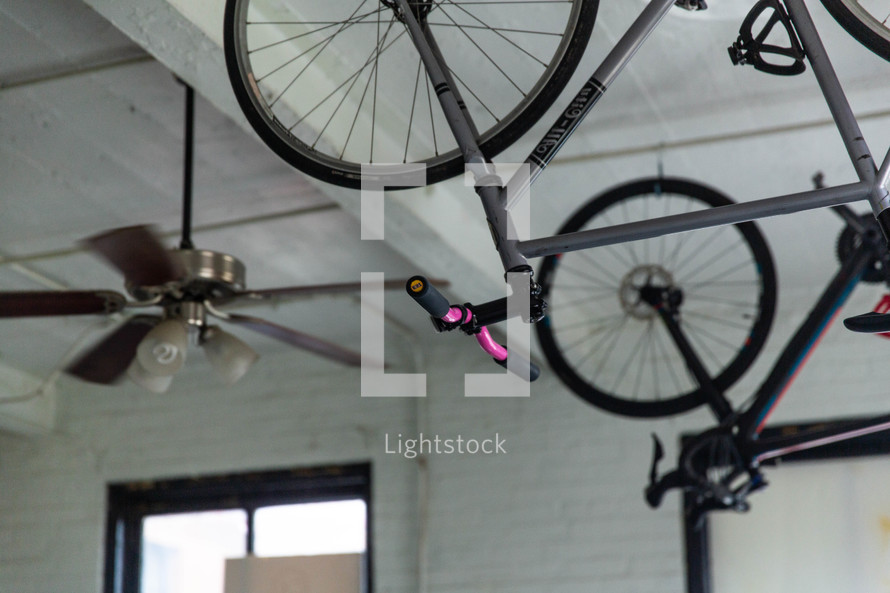 bikes hanging from a ceiling in an apartment 
