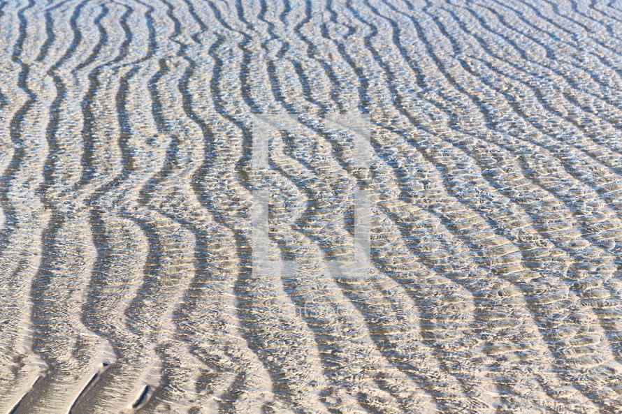 ripples in water and sand background 