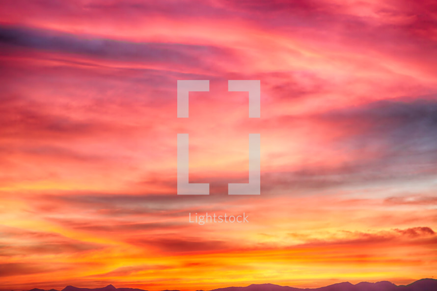 fuchsia, red, purple, pink, orange, and yellow vibrant sky at sunset background 