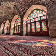 colorful sunlight on rugs through stained glass windows in a mosque 