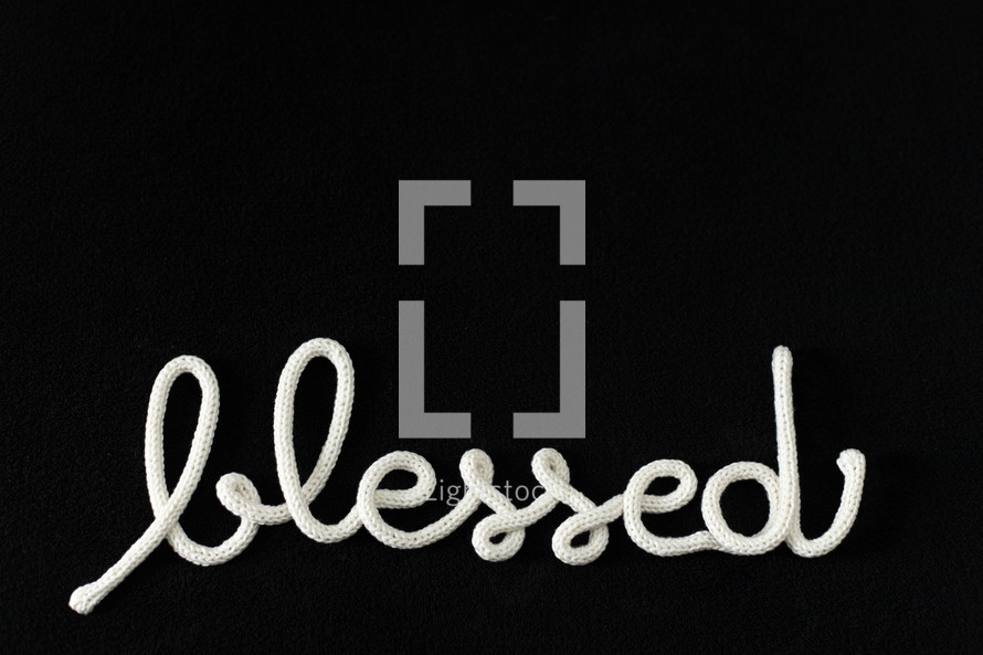 word blessed in rope on a black background 
