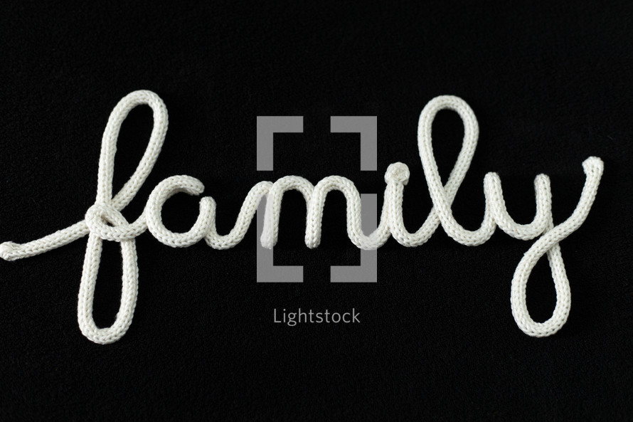 word family in rope on a black background 