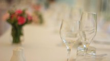 wedding flowers and wine glasses on a table 