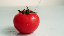 Injection into fresh red tomato.
