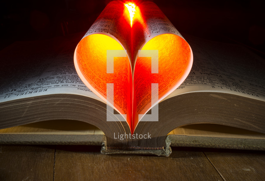 glowing heart from the pages of a Bible 