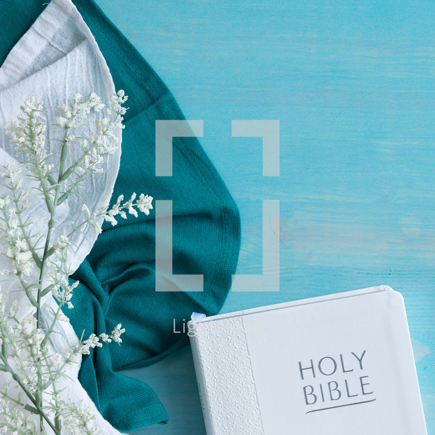 white bible and linen on blue with Bible 