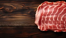 Slices of raw bacon on dark wooden background, top view
