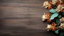 Dried flowers on wooden background with copy space. Top view.