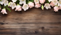 Bouquet of bellflowers on wooden background with copy space