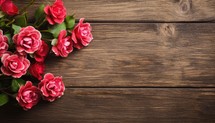 Bouquet of red roses on wooden background. Top view with copy space