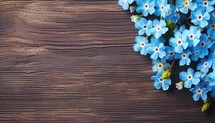 Forget-me-not flowers on wooden background, top view