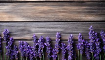 Bunch of lavender flowers on wooden background. Top view.