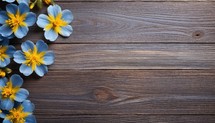 Spring flowers on wooden background. Top view with copy space for your text