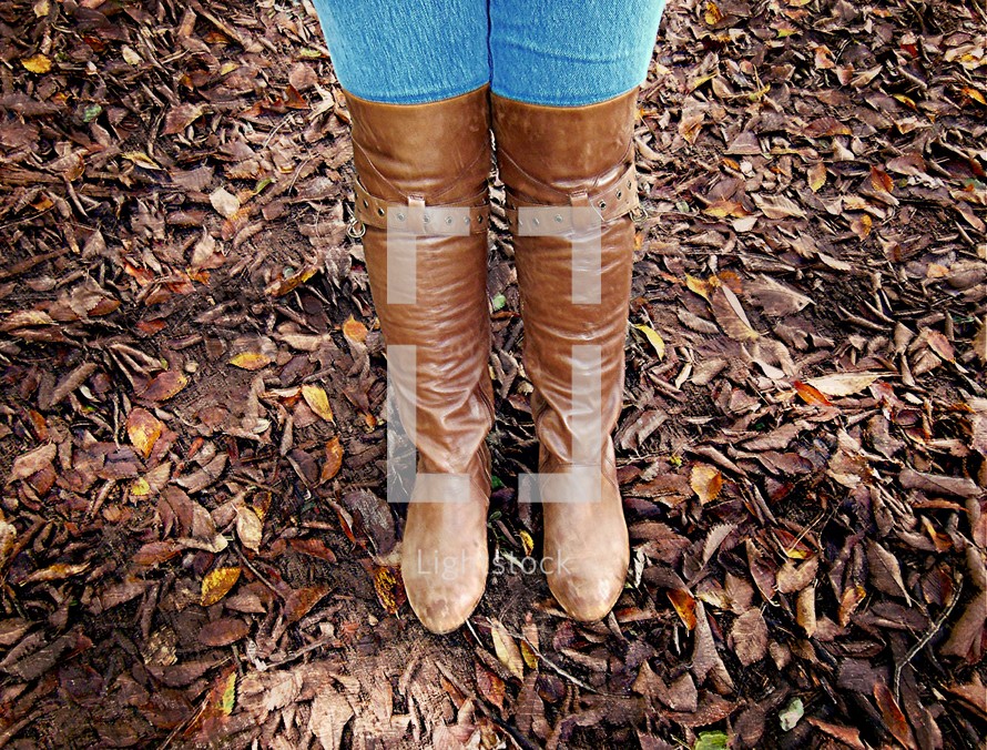 leather boots standing in fall leaves 