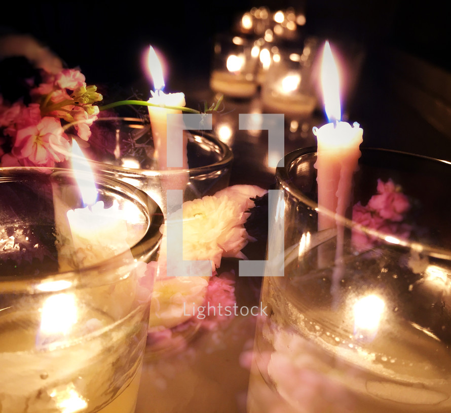 Double exposure candles and flowers in dark space - soft effect