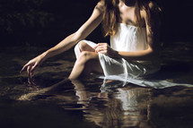 a woman sitting in water 
