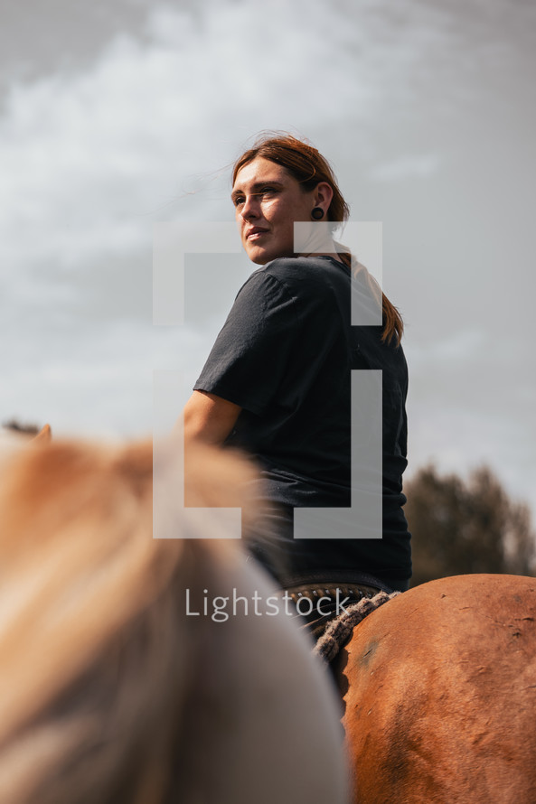 Woman riding a horse in summer, horseback photo