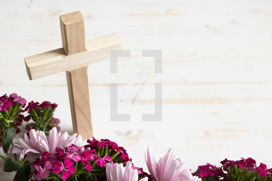 cross and pink flowers on a white background 