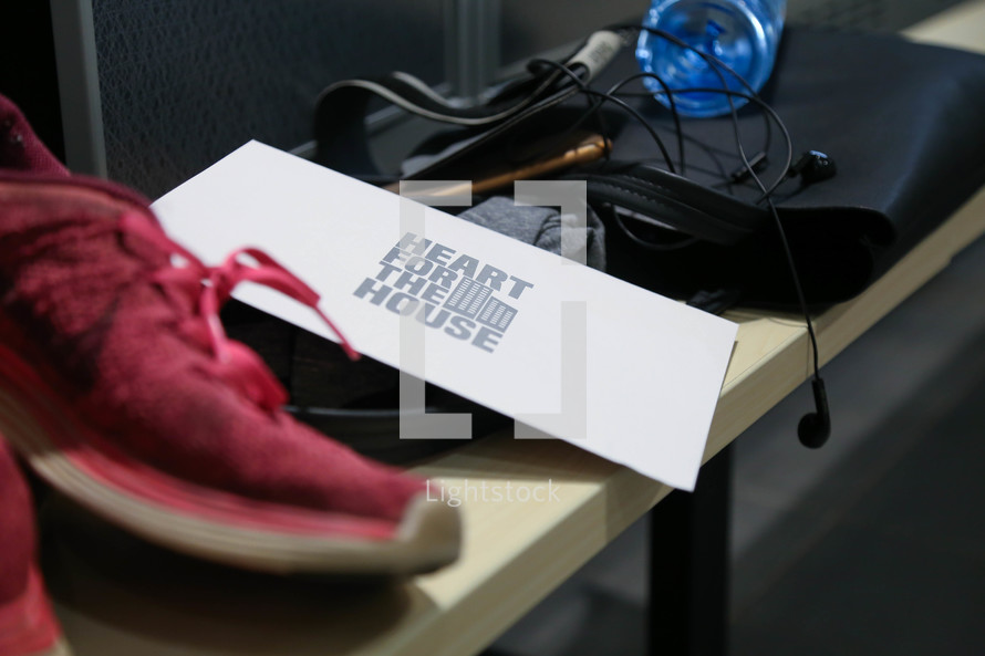 heart for the house envelope, sneakers, earbuds, water bottle, and bag