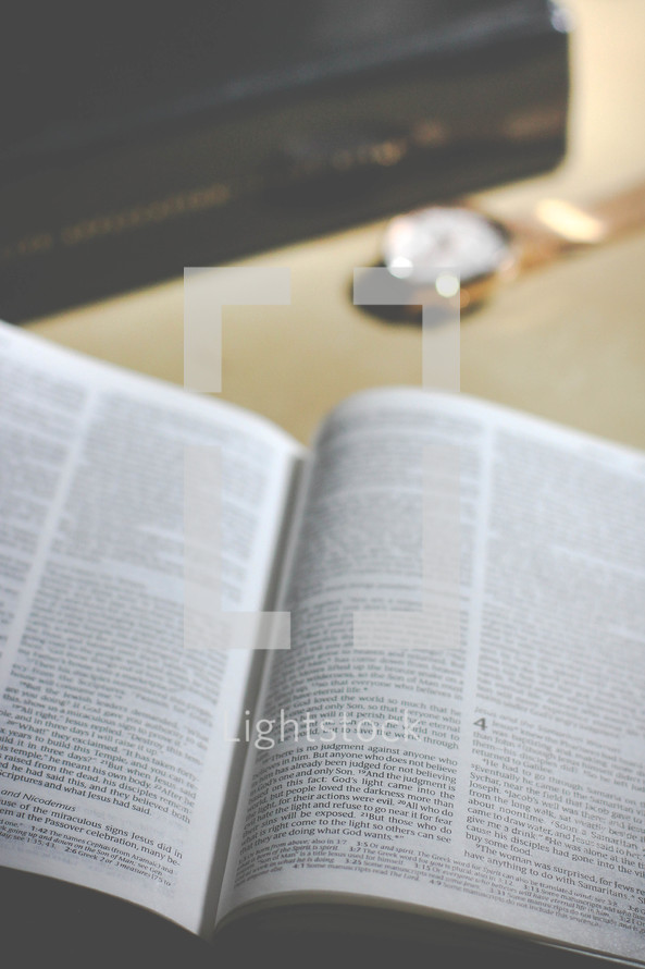 open Bible on a table and watch 