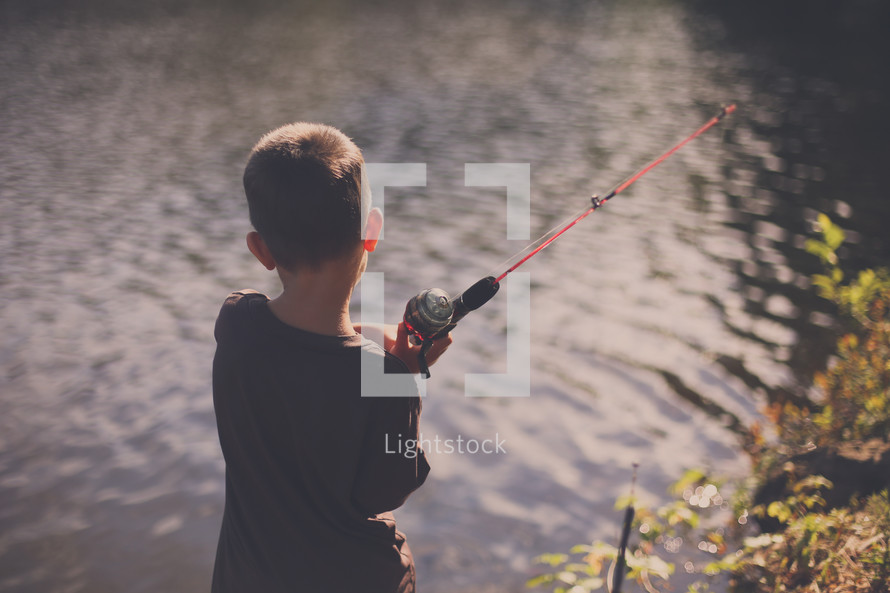 boy child fishing in a lake 
