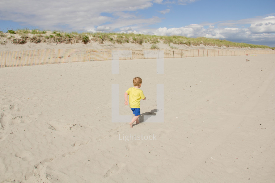 Boy running on the beach.