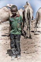 child near camels in Ethiopia 