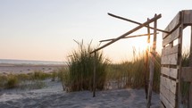 Wooden Refuge On The Beach With A Beautiful Sunset Behind The Dune Grass In Langeoog Island, Germany. - timelapse