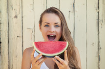 a young woman eating watermelon 