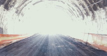 Traveling shot inside a large tunnel during construction.
