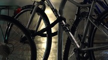 Close-up of bicycles in a bike rack in the rain.