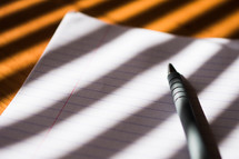 a pen on paper in sunlight 