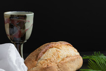 chalice and bread loaf for communion and palm frond 