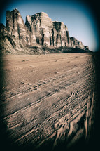 tire tracks in desert sands