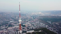 Transmit mast on a city hill in summer