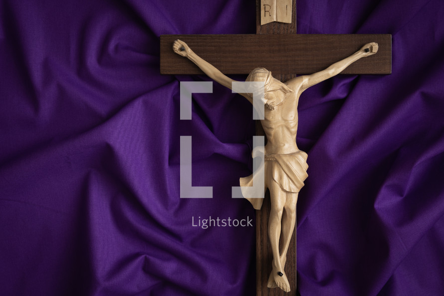 Crucifix on a purple cloth background