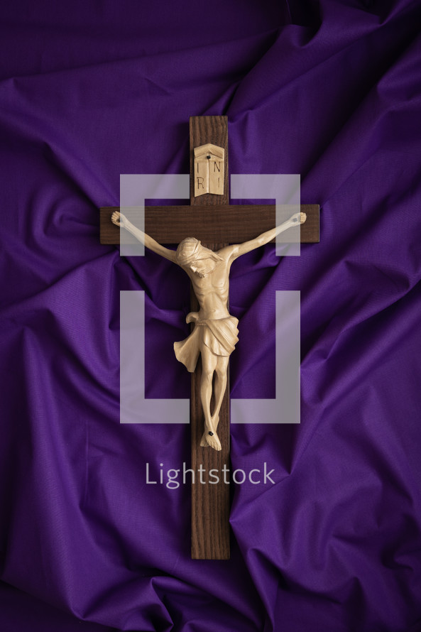 Crucifix on a purple cloth background
