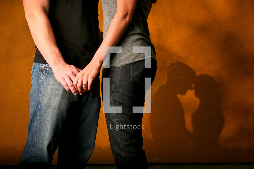 couple holding hands and shadow of a couple 