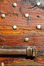 brass hardware on a wood door 