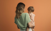 Mother with baby on an orange background