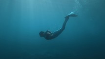 Mermaid in the depths of the ocean water