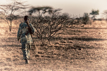 a soldier carrying a rifle in Africa 