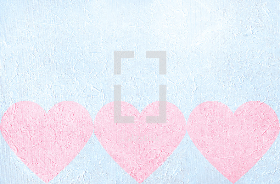 light pink hearts on light blue textural gesso background