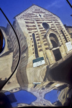 Santo Stefano church in Verona in a reflexion of a car