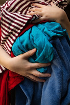 a woman holding dirty clothes 